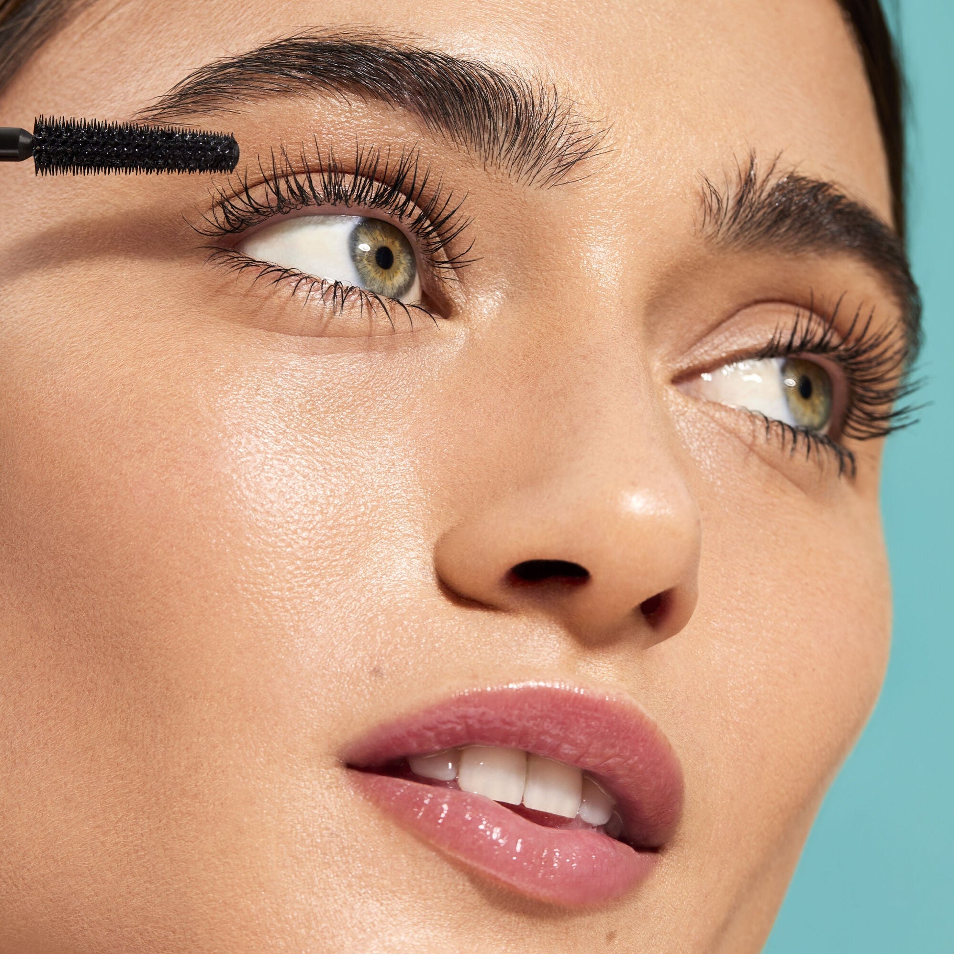 Close-up of a woman applying mascara